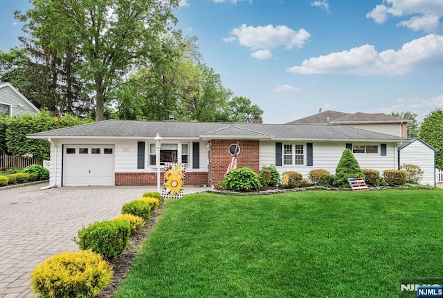 247 Wayne Ave, River Edge, NJ 07661 - view of front of house featuring an attached garage, decorative driveway, brick siding, and a front yard