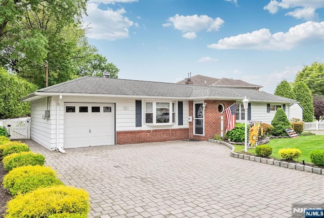 247 Wayne Ave, River Edge, NJ 07661 - ranch-style house featuring an attached garage, brick siding, driveway, and a gate