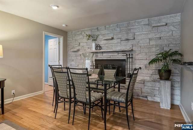 247 Wayne Ave, River Edge, NJ 07661 - dining space with a stone fireplace, wood finished floors, and baseboards