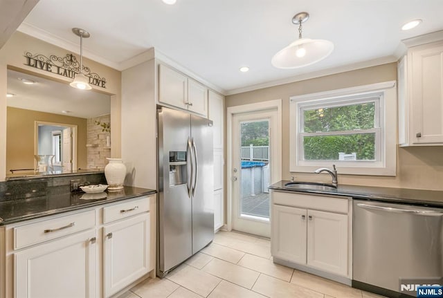 247 Wayne Ave, River Edge, NJ 07661 - kitchen featuring appliances with stainless steel finishes, a sink, crown molding, decorative light fixtures, and light tile patterned floors