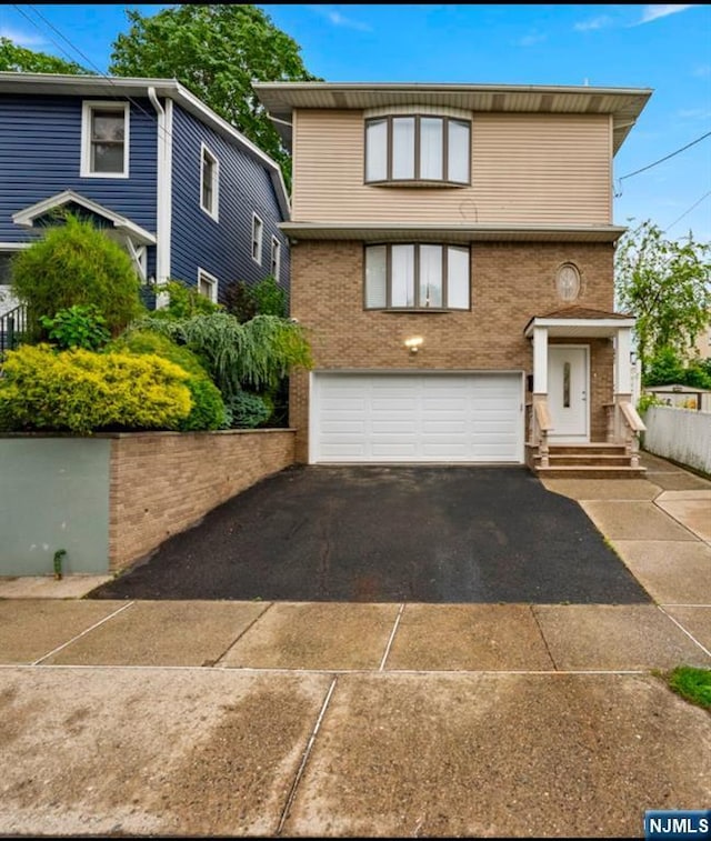 409 Washington St, Carlstadt, NJ 07072 - traditional-style home featuring driveway, a garage, and brick siding