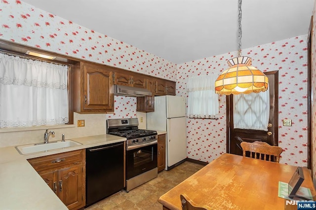 21 Spruce Ave, Ridgefield Park, NJ 07660 - kitchen featuring black dishwasher, gas stove, wallpapered walls, light countertops, and under cabinet range hood
