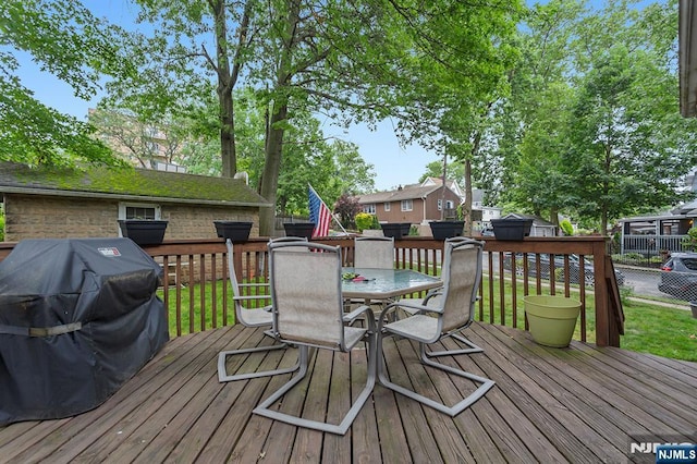 21 Spruce Ave, Ridgefield Park, NJ 07660 - wooden deck with outdoor dining area, a grill, and a lawn