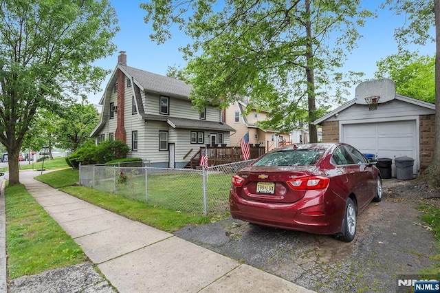 21 Spruce Ave, Ridgefield Park, NJ 07660 - view of front facade featuring a chimney, an outdoor structure, and driveway