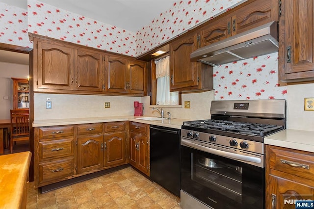 21 Spruce Ave, Ridgefield Park, NJ 07660 - kitchen with stainless steel gas range oven, dishwasher, wallpapered walls, under cabinet range hood, and light countertops
