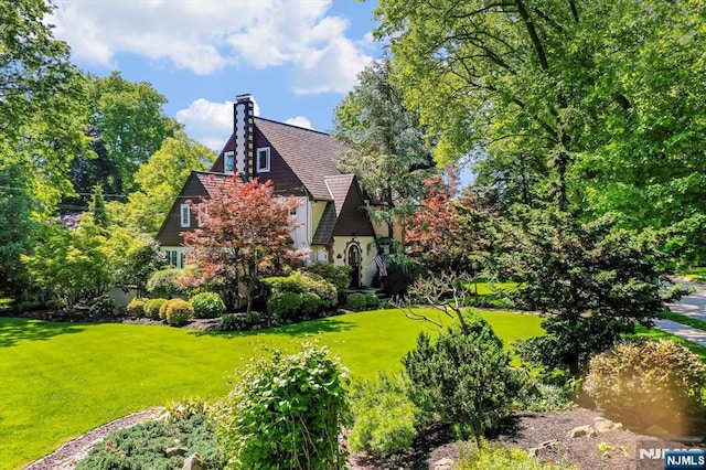 747 Mildred St, Teaneck, NJ 07666 - view of side of property with a lawn and a chimney