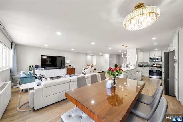 2180 Center 4B, Fort Lee, NJ 07024 - dining space with a chandelier, light wood-type flooring, recessed lighting, and radiator heating unit