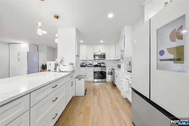 2180 Center 4B, Fort Lee, NJ 07024 - kitchen with appliances with stainless steel finishes, light wood-type flooring, white cabinetry, tasteful backsplash, and recessed lighting