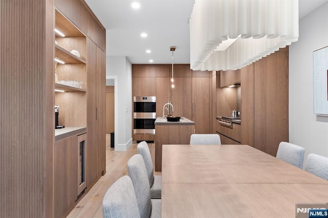 10 Kensington Ct, Tenafly, NJ 07670 - dining room featuring light wood-style floors, recessed lighting, and built in shelves