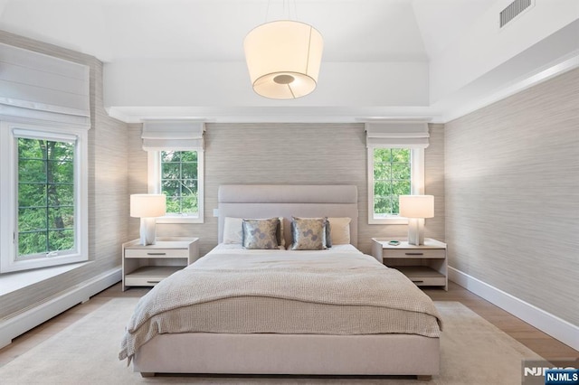 10 Kensington Ct, Tenafly, NJ 07670 - bedroom featuring baseboards, wallpapered walls, multiple windows, and light wood-style flooring