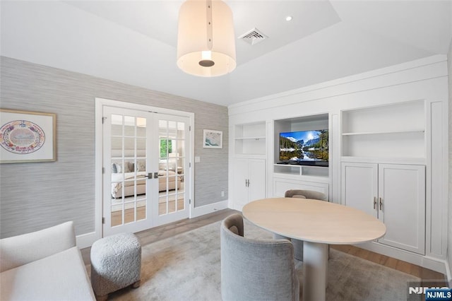 10 Kensington Ct, Tenafly, NJ 07670 - dining area with french doors, wood finished floors, wallpapered walls, baseboards, and built in shelves