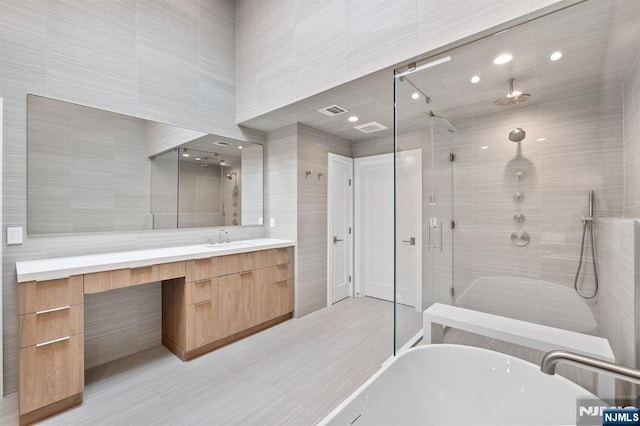 10 Kensington Ct, Tenafly, NJ 07670 - bathroom featuring a freestanding tub, a stall shower, vanity, and tile walls