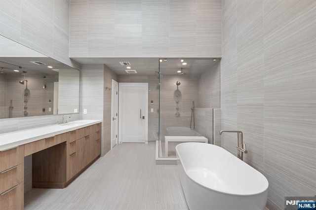 10 Kensington Ct, Tenafly, NJ 07670 - full bathroom with a shower stall, tile walls, vanity, and a freestanding tub