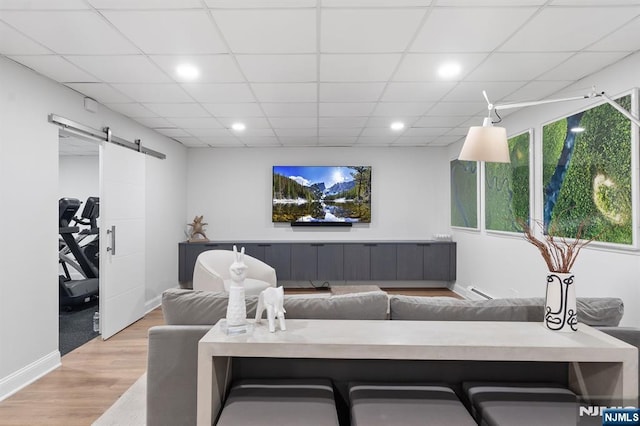 10 Kensington Ct, Tenafly, NJ 07670 - living room with a barn door, wood finished floors, recessed lighting, a baseboard heating unit, and baseboards