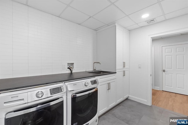 10 Kensington Ct, Tenafly, NJ 07670 - washroom featuring washer and clothes dryer, cabinet space, and light tile patterned flooring