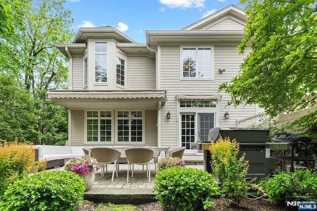 10 Kensington Ct, Tenafly, NJ 07670 - back of property with a patio area and an outdoor living space