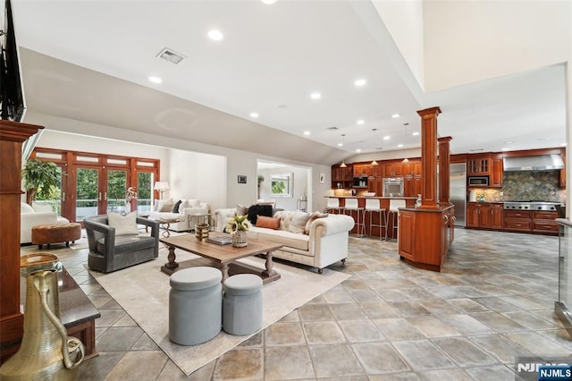 15 Fred St, Old Tappan, NJ 07675 - living area with decorative columns, lofted ceiling, healthy amount of natural light, and recessed lighting
