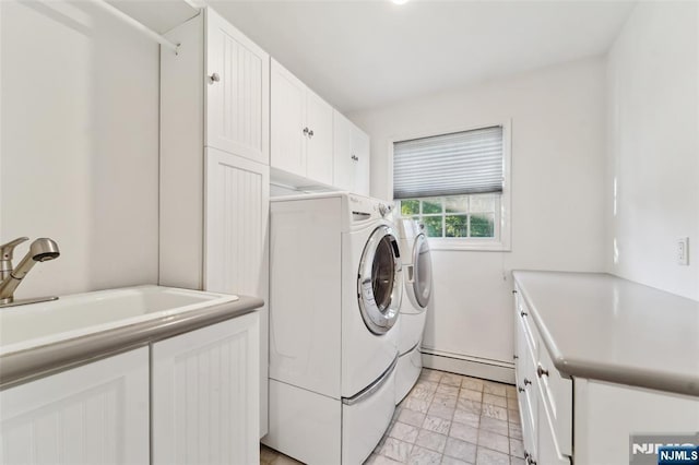 15 Fred St, Old Tappan, NJ 07675 - laundry area featuring baseboard heating, cabinet space, washing machine and clothes dryer, and light stone finish floors