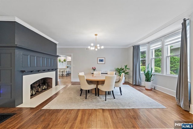 296 Highfield Ln, Nutley, NJ 07110 - dining space featuring a chandelier, wood finished floors, baseboards, and crown molding