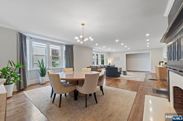 296 Highfield Ln, Nutley, NJ 07110 - dining area featuring crown molding, a chandelier, recessed lighting, light wood-type flooring, and baseboards
