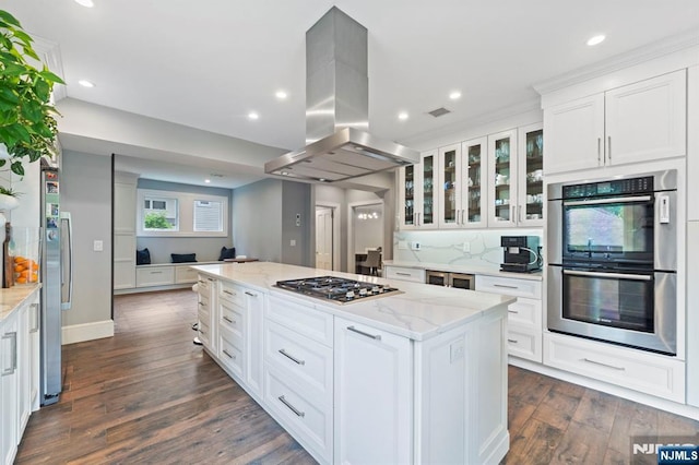 296 Highfield Ln, Nutley, NJ 07110 - kitchen with stainless steel appliances, island exhaust hood, dark wood-style floors, white cabinets, and a kitchen island