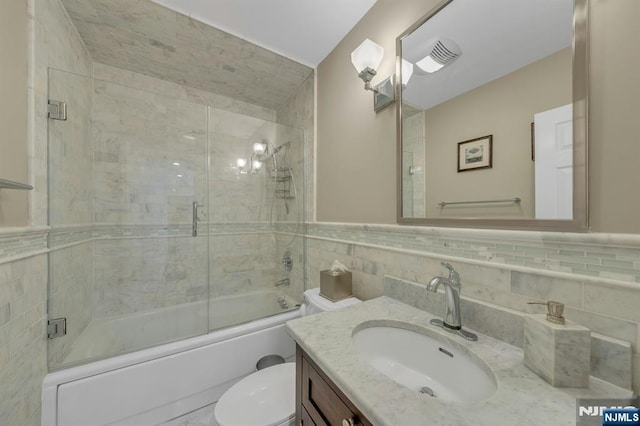 248 Camden St, Oradell, NJ 07649 - full bathroom featuring tile walls, shower / bath combination with glass door, toilet, and vanity