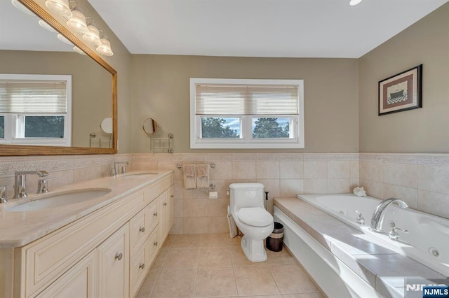 248 Camden St, Oradell, NJ 07649 - bathroom with tile patterned flooring, tile walls, toilet, a jetted tub, and double vanity