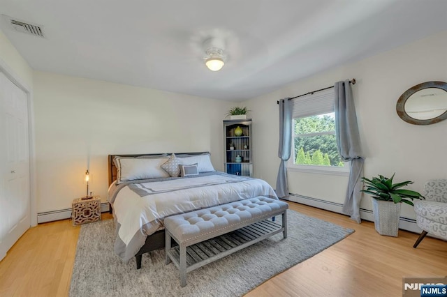 248 Camden St, Oradell, NJ 07649 - bedroom featuring a baseboard radiator and light wood finished floors