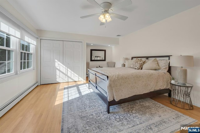 248 Camden St, Oradell, NJ 07649 - bedroom featuring baseboard heating, light wood-style flooring, a ceiling fan, and a closet