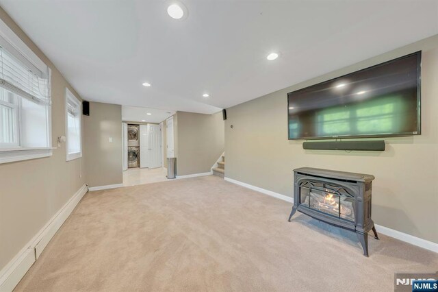 248 Camden St, Oradell, NJ 07649 - basement with carpet floors, a wood stove, stairway, baseboards, and recessed lighting