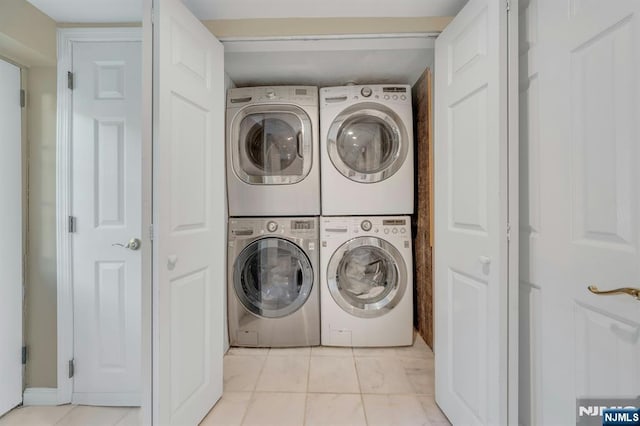 248 Camden St, Oradell, NJ 07649 - washroom with stacked washer / drying machine and light tile patterned floors