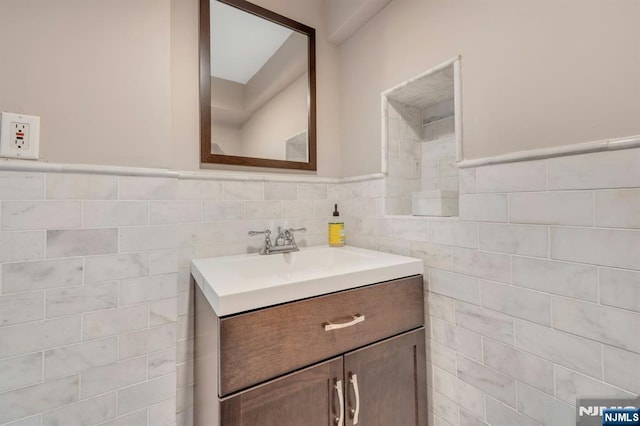248 Camden St, Oradell, NJ 07649 - bathroom featuring vanity, tile walls, and a wainscoted wall
