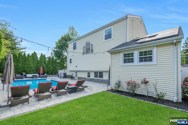 248 Camden St, Oradell, NJ 07649 - back of property with roof mounted solar panels, a yard, and a patio area