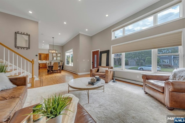 248 Camden St, Oradell, NJ 07649 - living area with a baseboard heating unit, light wood finished floors, ornamental molding, stairs, and recessed lighting