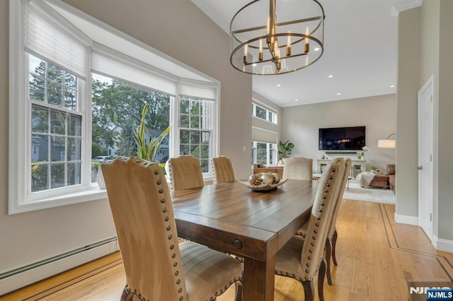 248 Camden St, Oradell, NJ 07649 - dining space with a baseboard radiator, a chandelier, light wood finished floors, baseboards, and ornamental molding