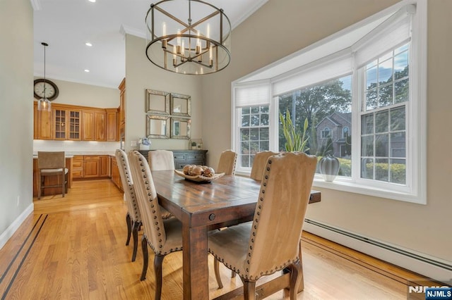 248 Camden St, Oradell, NJ 07649 - dining area with a baseboard heating unit, plenty of natural light, light wood-style floors, a chandelier, and crown molding