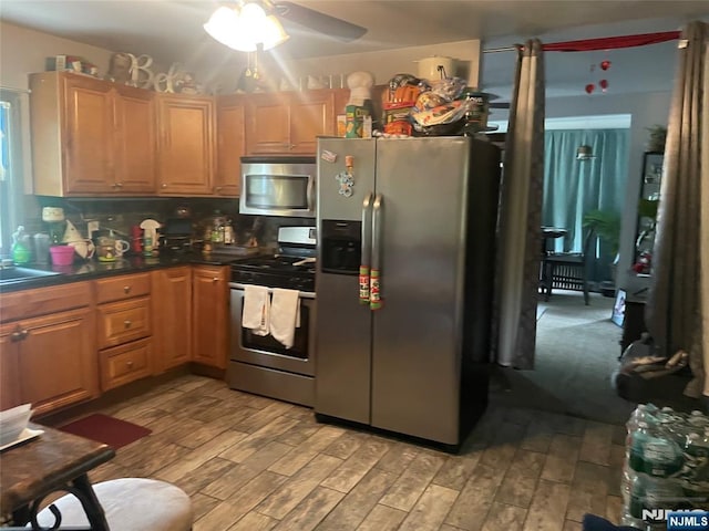 67-69 Garret St, Paterson, NJ 07501 - kitchen with appliances with stainless steel finishes, ceiling fan, light wood-style flooring, dark countertops, and tasteful backsplash
