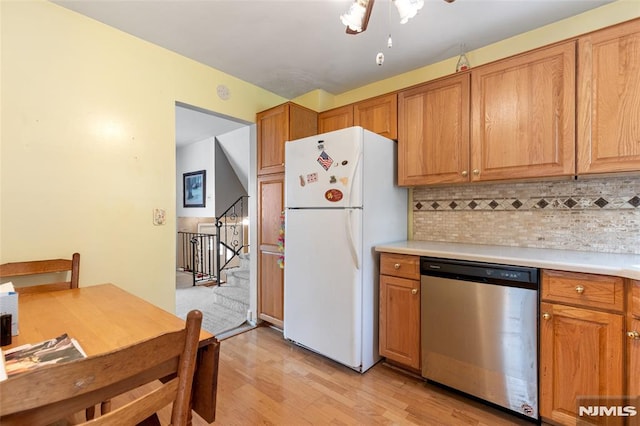 104 Richard St, Rockaway Township, NJ 07801 - kitchen with dishwasher, freestanding refrigerator, tasteful backsplash, light wood-style flooring, and light countertops