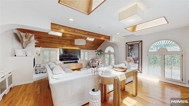263 Standish Rd, Ridgewood, NJ 07450 - living area featuring light wood-style flooring, lofted ceiling, recessed lighting, arched walkways, and a skylight