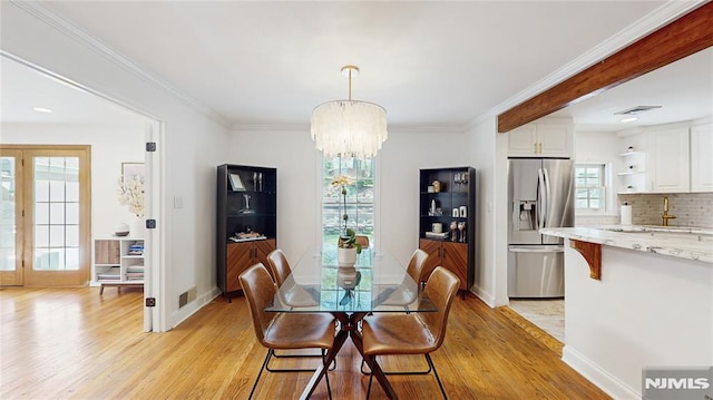 263 Standish Rd, Ridgewood, NJ 07450 - dining space featuring light wood-style floors, a chandelier, baseboards, and crown molding