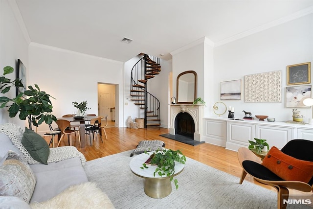 167 Wayne St Unit 407, Jersey City, NJ 07302 - living area featuring crown molding, stairs, light wood-type flooring, and a fireplace with raised hearth