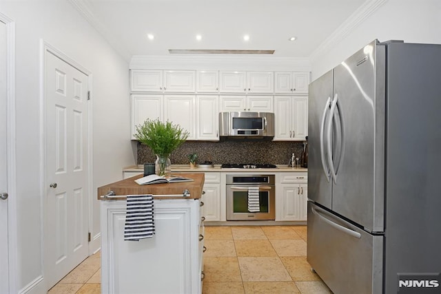167 Wayne St Unit 407, Jersey City, NJ 07302 - kitchen featuring appliances with stainless steel finishes, white cabinetry, decorative backsplash, ornamental molding, and recessed lighting