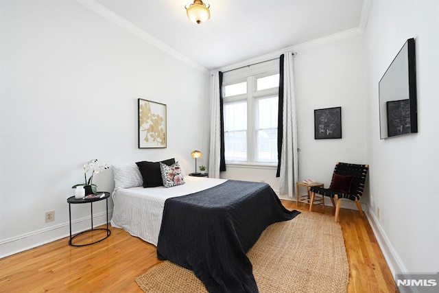 167 Wayne St Unit 407, Jersey City, NJ 07302 - bedroom with ornamental molding, light wood-style flooring, and baseboards