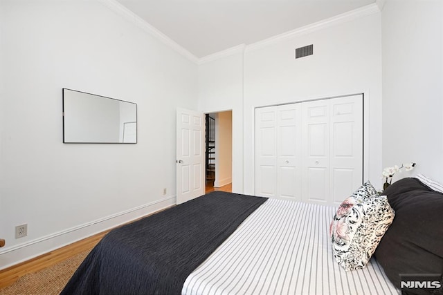 167 Wayne St Unit 407, Jersey City, NJ 07302 - bedroom with crown molding, wood finished floors, a closet, and baseboards