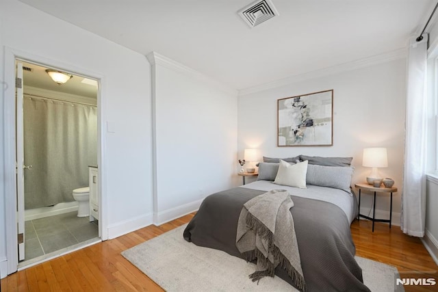 167 Wayne St Unit 407, Jersey City, NJ 07302 - bedroom with light wood-style floors, crown molding, ensuite bathroom, and baseboards