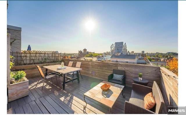 167 Wayne St Unit 407, Jersey City, NJ 07302 - wooden deck featuring outdoor dining area and a city view