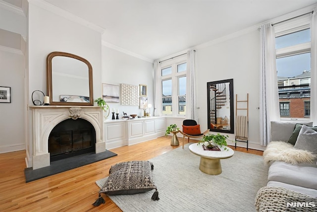 167 Wayne St Unit 407, Jersey City, NJ 07302 - living room with crown molding, light wood finished floors, a fireplace, and stairway