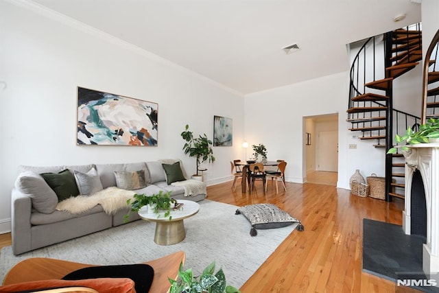 167 Wayne St Unit 407, Jersey City, NJ 07302 - living area featuring ornamental molding, stairs, wood finished floors, and baseboards