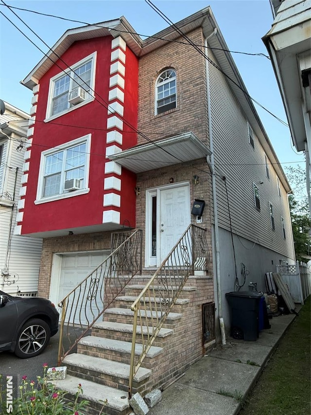 74 Kenmore Ave, Newark, NJ 07106 - view of front of house with brick siding, a garage, and cooling unit