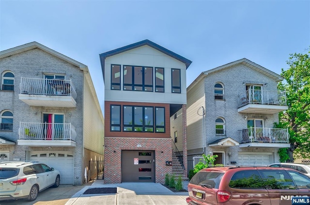 85 Myrtle Ave, Jersey City, NJ 07305 - view of front of house with an attached garage, brick siding, and driveway